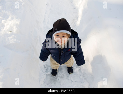 Asian baby boy in snow Stock Photo