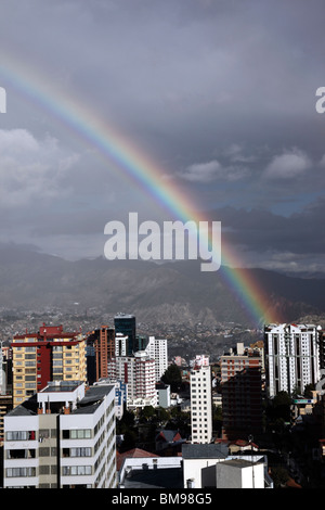 Rainbow and stormy skies over high rise buildings in Sopocachi, central La Paz in rainy season, Bolivia Stock Photo