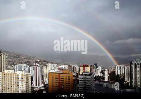 Rainbow and stormy skies over high rise buildings in Sopocachi, central La Paz in rainy season, Bolivia Stock Photo