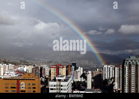 Rainbow and stormy skies over high rise buildings in Sopocachi, central La Paz in rainy season, Bolivia Stock Photo