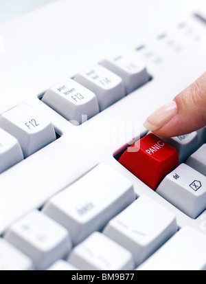 Person pushing Panic key on Keyboard Stock Photo