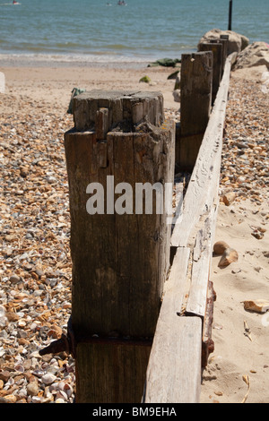 wooden beach groyne on beach with sea Stock Photo