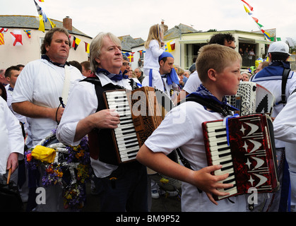 followers of the blue oss marching through the streets of padstow, cornwall on obby oss day Stock Photo