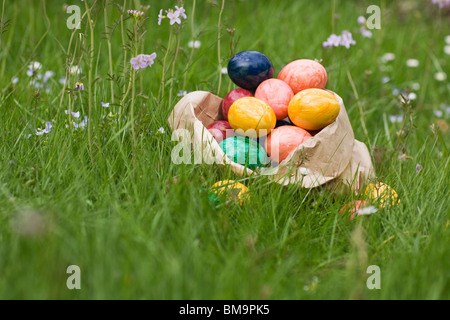 Paper Bag full of Easter eggs in Grass Stock Photo