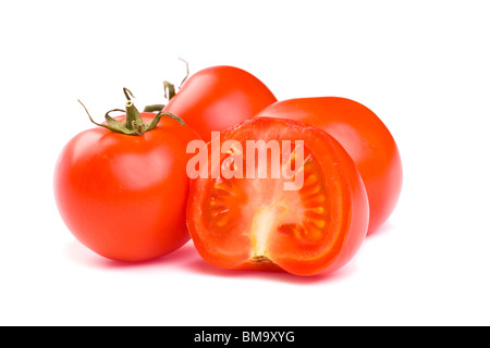 Ripe red tomatoes on a white background with clipping path. The focus is on the sliced tomato in front.