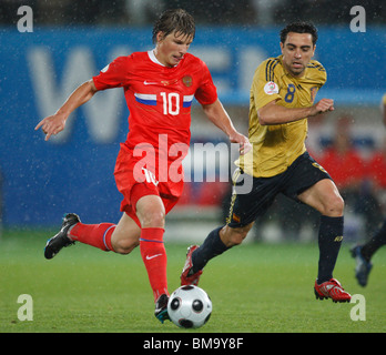Andrei Arshavin of Russia (10) drives the ball as Xavi Hernandez of Spain (8) defends during a UEFA Euro 2008 semi-final match. Stock Photo