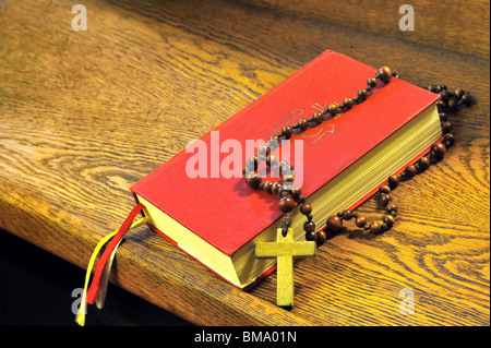 Hymnal  book and wooden rosary bead- detail Stock Photo
