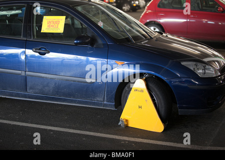 Vehicle clamped by police for being untaxed (licence not paid for for and not displaying tax disc) in UK Stock Photo