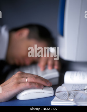 Businessman sleeping at the computer Stock Photo