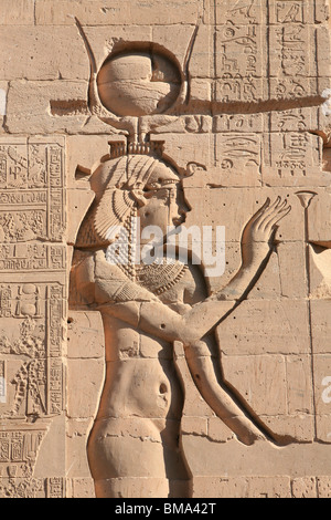 Relief of the Egyptian Goddess Hathor on the wall of the first pylon at the Temple of Philae in Egypt Stock Photo