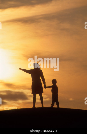 Mother and son on hilltop. Stock Photo