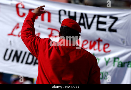 Venezuela's President Hugo Chavez wearing a red beret waves to supporters at a rally in Caracas, Venezuela, August 28, 2003.