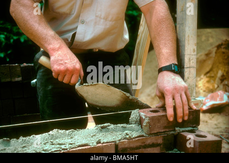 Brick layer constructing a wall. Stock Photo