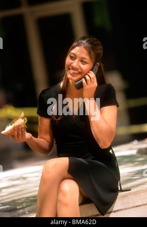 Woman on cell phone while on lunch break. Stock Photo