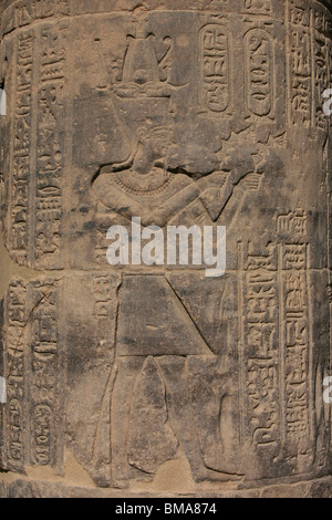 A bas-relief of pharaoh Ptolemy II making offerings on a column at the Temple of Philae in Egypt Stock Photo