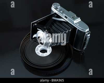 Camera and roll of film Stock Photo