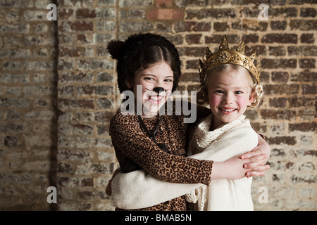 Young girls dressed up as cat and queen Stock Photo