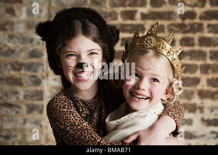 Young girls dressed up as cat and queen Stock Photo