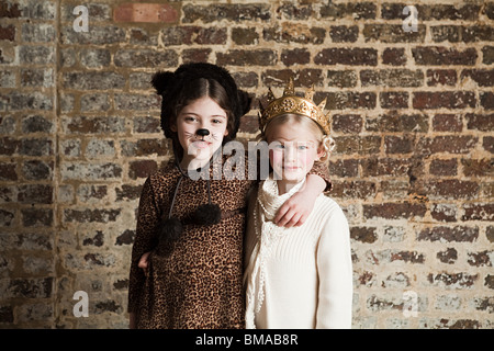 Young girls dressed up as cat and queen Stock Photo