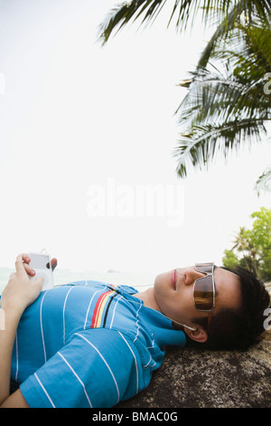 Man Listening to MP3 Player Outdoors Stock Photo