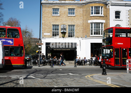 Buses passing on Kings Road, Chelsea, London, UK Stock Photo