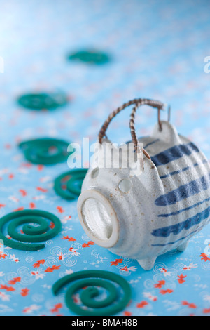 Mosquito Coil and Pig-shaped Container Stock Photo