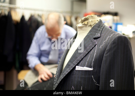A tailor in the workshop of Henry Poole in Savile Row, London. Stock Photo