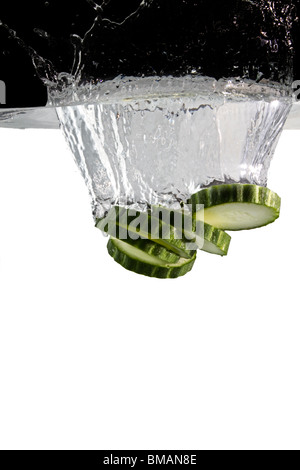 some cucumber thrown in water with black and white background Stock Photo