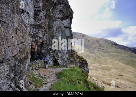 The ' Priest Hole' , a cave situated on the vertical North East face of Dove Crag in the Lake District Stock Photo