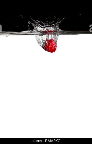 one raspberry thrown in water with black and white background Stock Photo