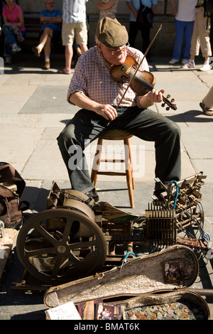 One-man band busker, musician who playing a number of instruments at ...