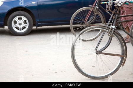 Street scene ; wheels of cycle rickshaw and car on Dhaka ; Bangladesh Stock Photo