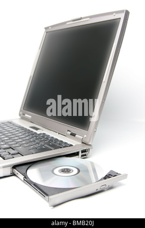 cd or dvd disk in the drive of a laptop Stock Photo