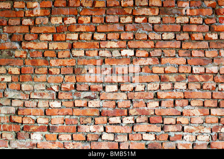 The ancient red brick wall - grunge background Stock Photo