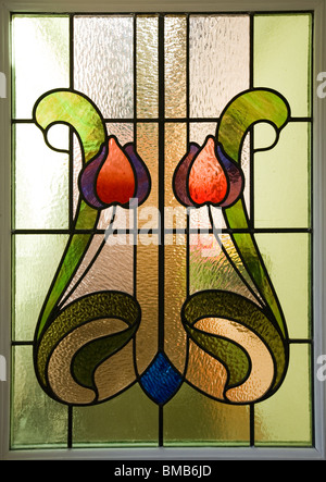 Houses Edwardian arts and crafts house, colourful art nouveau stained glass window panel Stock Photo