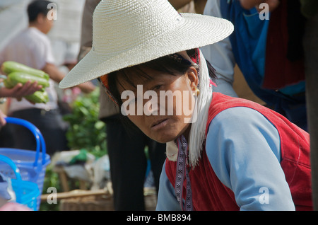 Portrait female Bai trader with large straw hat Shaping Market Yunnan China Stock Photo