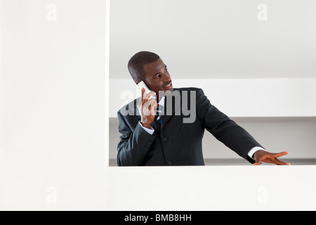 young adult afro-american businessman talking on the phone indoors. Copy space Stock Photo