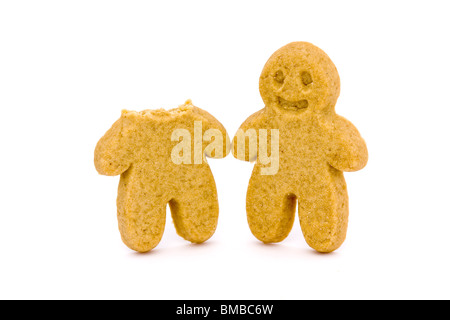 two gingerbread men one with head bitten off on a white background Stock Photo