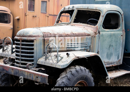 abandoned  rusty old antique truck  in a field Stock Photo
