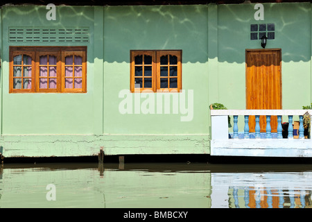 Typical Bangkok canal with houses on stilts. Stock Photo