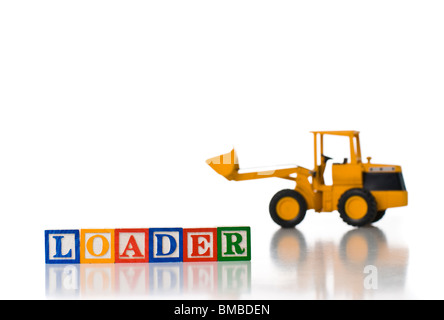 Colorful children's blocks spelling LOADER with a tractor Stock Photo