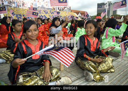 Young performers waving the Malaysian flag, Merdeka Square, Kuala Lumpur, Malaysia Stock Photo