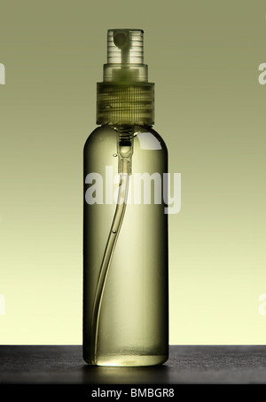 Water in a small spray bottle against backdrop. Stock Photo