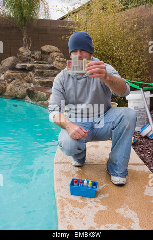 Man checking the ph level of a swimming pool. Stock Photo