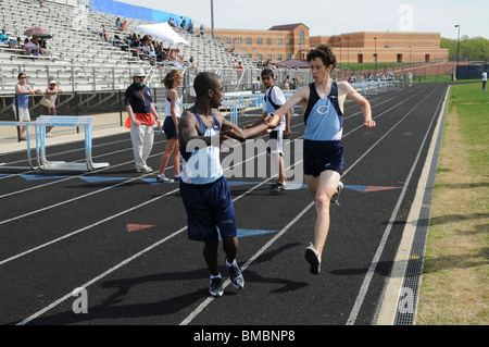 2 runners in a relay race in a track event Stock Photo