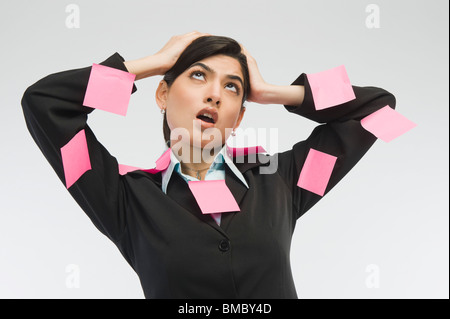 Adhesive notes on businesswoman's dress Stock Photo