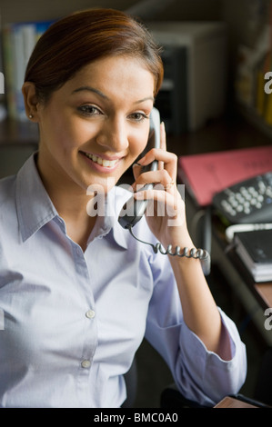Businesswoman talking on the telephone in an office Stock Photo
