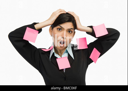 Adhesive notes on businesswoman's dress Stock Photo