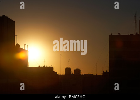 sun setting over rooftops in the evening buenos aires argentina Stock Photo