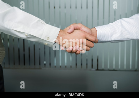 Close-up of two businessmen shaking hands Stock Photo